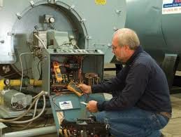 man repairing a boiler