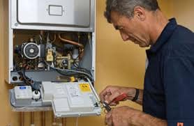 man repairing a boiler