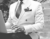 man in a suit using a laptop